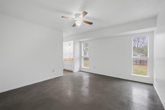 12503 Brandywine Ct, Austin, TX 78727 - spare room with concrete flooring, baseboards, a textured ceiling, and a ceiling fan