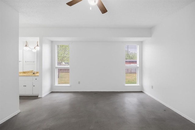 12503 Brandywine Ct, Austin, TX 78727 - unfurnished room with healthy amount of natural light, baseboards, a ceiling fan, and finished concrete flooring