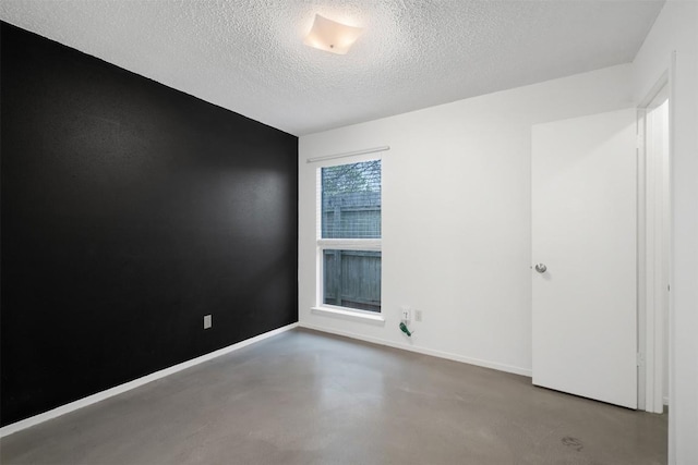 12503 Brandywine Ct, Austin, TX 78727 - unfurnished room featuring finished concrete flooring, a textured ceiling, and baseboards