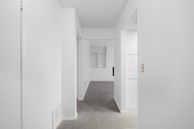 12503 Brandywine Ct, Austin, TX 78727 - corridor featuring baseboards and concrete flooring