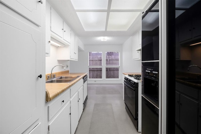12503 Brandywine Ct, Austin, TX 78727 - kitchen featuring black range with gas cooktop, a sink, and white cabinetry