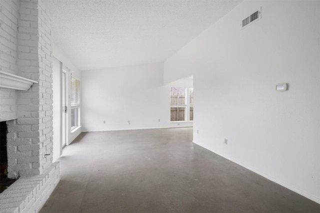 12503 Brandywine Ct, Austin, TX 78727 - unfurnished living room with a fireplace, baseboards, finished concrete flooring, and a textured ceiling