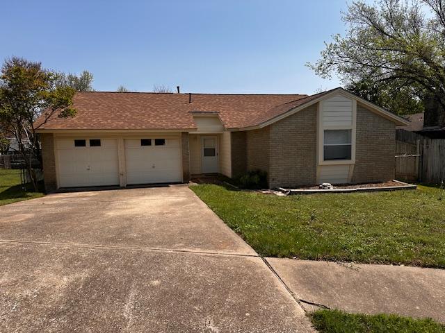 12503 Brandywine Ct, Austin, TX 78727 - ranch-style home with brick siding, concrete driveway, and an attached garage