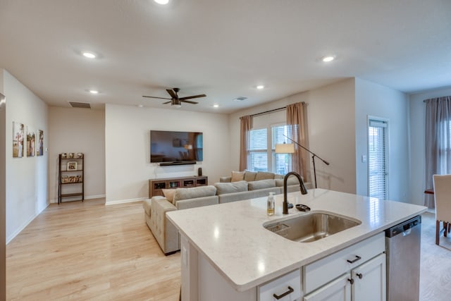 312 Heatherwood Ter, Marble Falls, TX 78654 - kitchen featuring stainless steel dishwasher, visible vents, light wood-style floors, and a sink