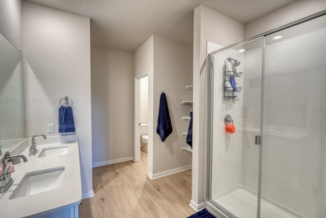 312 Heatherwood Ter, Marble Falls, TX 78654 - full bathroom with a stall shower, wood finished floors, and a sink