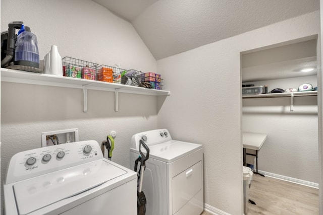 312 Heatherwood Ter, Marble Falls, TX 78654 - laundry area featuring separate washer and dryer, light wood-style flooring, laundry area, baseboards, and a textured wall