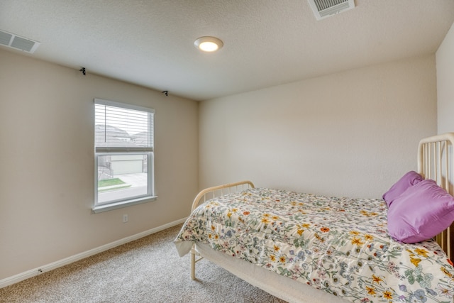 312 Heatherwood Ter, Marble Falls, TX 78654 - carpeted bedroom with baseboards, visible vents, and a textured ceiling