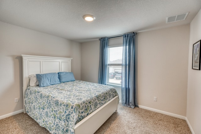 312 Heatherwood Ter, Marble Falls, TX 78654 - bedroom featuring baseboards, a textured ceiling, visible vents, and light carpet