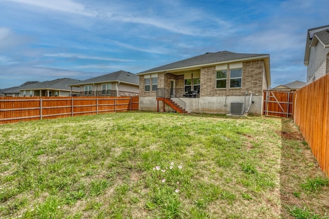 312 Heatherwood Ter, Marble Falls, TX 78654 - rear view of property with cooling unit, a fenced backyard, brick siding, and a yard