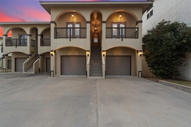 510 N Horseshoe Bay Blvd, Horseshoe Bay, TX 78657 - view of front of house featuring stucco siding, a balcony, stairs, and a garage