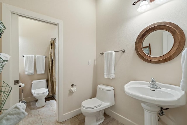 510 N Horseshoe Bay Blvd, Horseshoe Bay, TX 78657 - bathroom with toilet, tile patterned flooring, baseboards, and a shower with curtain