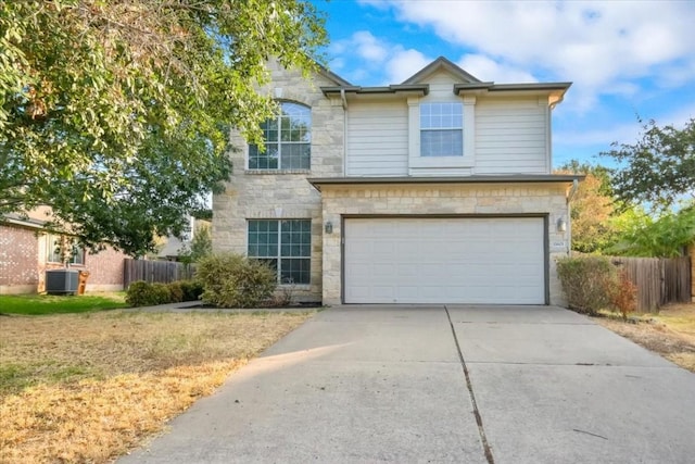 16101 Mcdows Hole Ln, Austin, TX 78717 - traditional-style house featuring stone siding, an attached garage, concrete driveway, and central AC