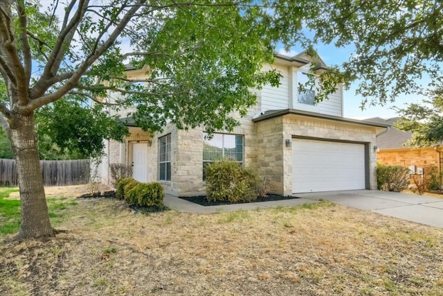 16101 Mcdows Hole Ln, Austin, TX 78717 - obstructed view of property with stone siding, an attached garage, and concrete driveway