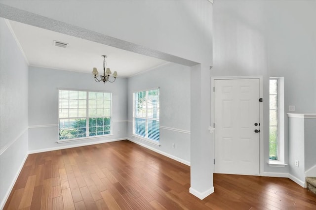 16101 Mcdows Hole Ln, Austin, TX 78717 - foyer entrance with a chandelier, wood finished floors, and ornamental molding