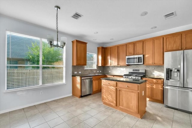 16101 Mcdows Hole Ln, Austin, TX 78717 - kitchen featuring appliances with stainless steel finishes, dark countertops, healthy amount of natural light, and backsplash