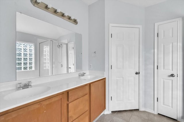 16101 Mcdows Hole Ln, Austin, TX 78717 - bathroom featuring a stall shower, double vanity, and tile patterned floors