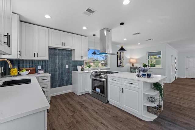 kitchen with gas range, island range hood, visible vents, and a sink
