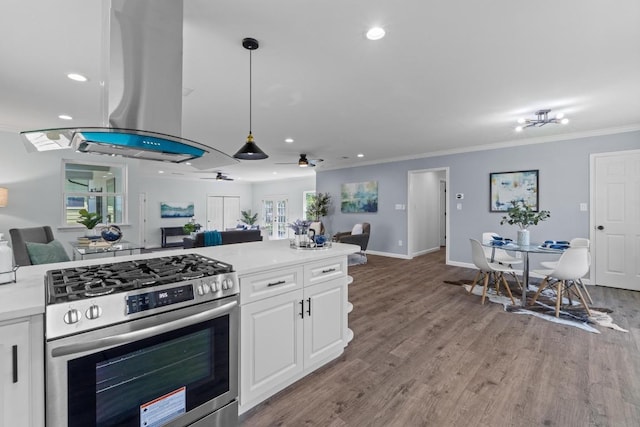 kitchen featuring open floor plan, ornamental molding, island exhaust hood, and gas stove