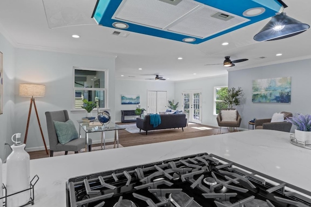 kitchen featuring a ceiling fan, crown molding, and visible vents