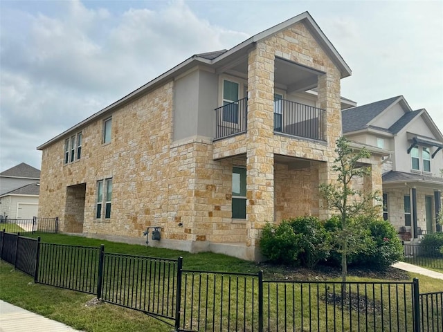 view of property exterior with stone siding, a lawn, fence, and a balcony