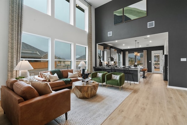 2705 Sage Ranch Dr Unit 32, Leander, TX 78641 - living room with a towering ceiling and light wood-type flooring