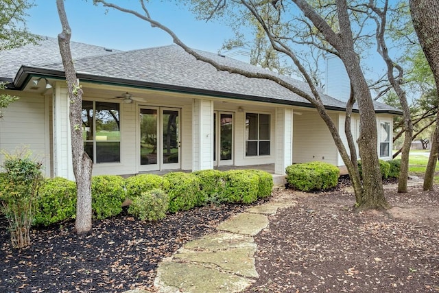 view of front of home with a porch, ceiling fan, and roof with shingles