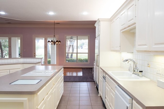 kitchen with crown molding, dishwasher, tile patterned floors, a sink, and backsplash
