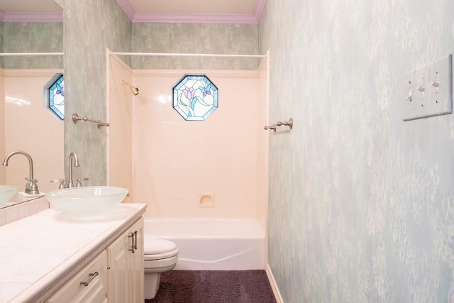 bathroom featuring bathtub / shower combination, ornamental molding, toilet, and vanity