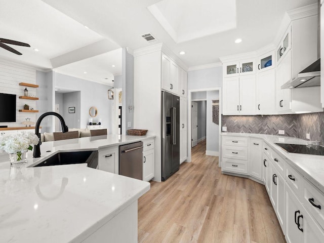 103 Waters Edge, Horseshoe Bay, TX 78657 - kitchen with appliances with stainless steel finishes, a sink, recessed lighting, light stone counters, and crown molding