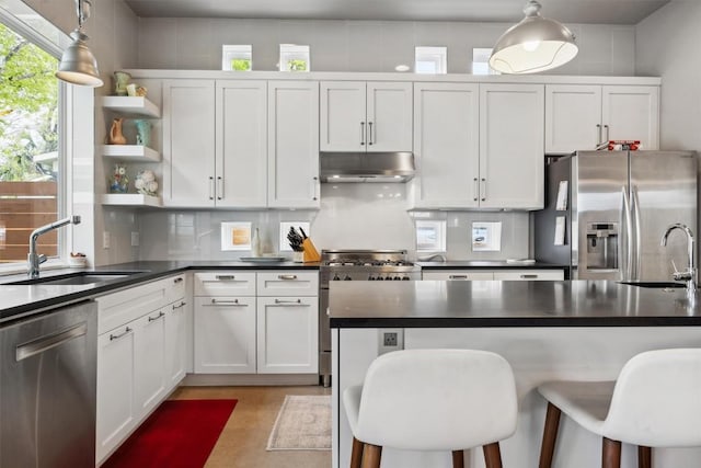 1506 Payne Ave Unit A, Austin, TX 78757 - kitchen featuring stainless steel appliances, under cabinet range hood, a sink, and dark countertops