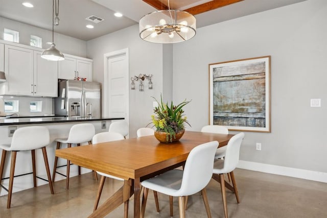 1506 Payne Ave Unit A, Austin, TX 78757 - dining area featuring baseboards, concrete floors, recessed lighting, and a chandelier