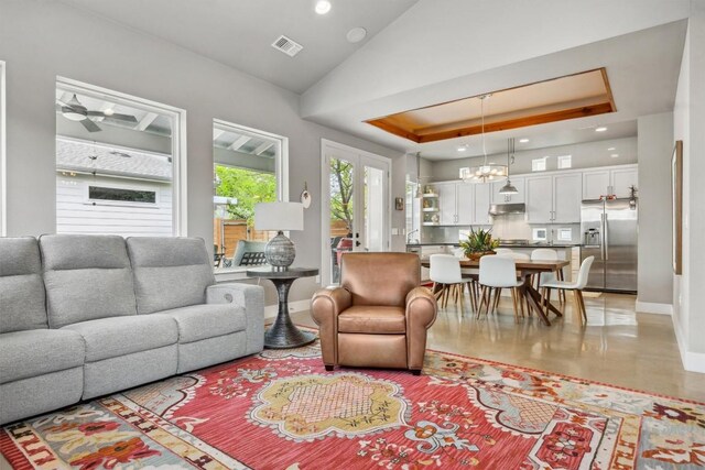 1506 Payne Ave Unit A, Austin, TX 78757 - living room featuring a raised ceiling, baseboards, recessed lighting, a chandelier, and ceiling fan