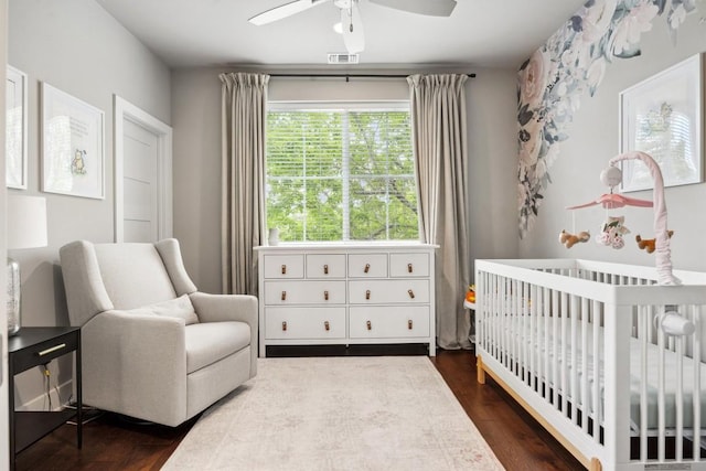1506 Payne Ave Unit A, Austin, TX 78757 - bedroom featuring a nursery area, dark wood-style flooring, and a ceiling fan