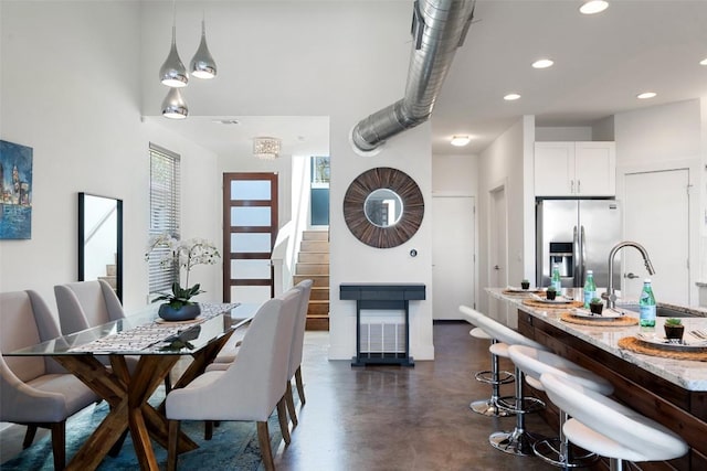 2514 E 4th St Unit A, Austin, TX 78702 - dining space with finished concrete floors, stairs, and recessed lighting