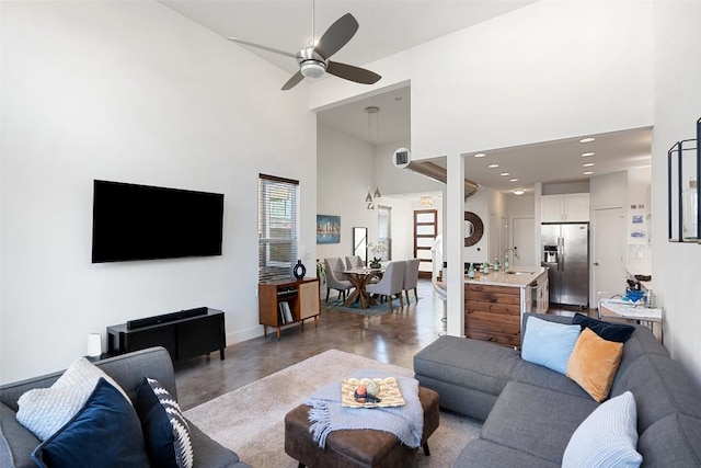 2514 E 4th St Unit A, Austin, TX 78702 - living area featuring concrete floors, a ceiling fan, a high ceiling, and recessed lighting