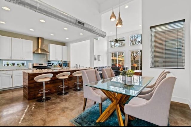 2514 E 4th St Unit A, Austin, TX 78702 - dining room with finished concrete floors, recessed lighting, and a towering ceiling