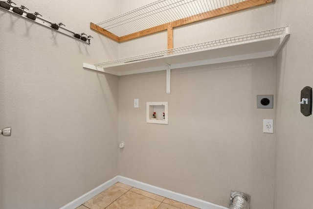 laundry area featuring hookup for a washing machine, laundry area, electric dryer hookup, light tile patterned floors, and baseboards