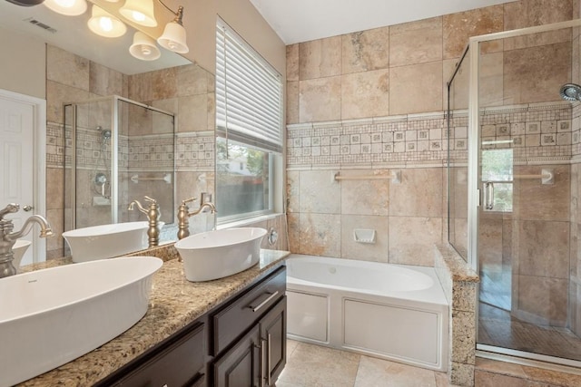 bathroom with a stall shower, a sink, a bath, and visible vents