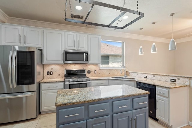 kitchen featuring appliances with stainless steel finishes, ornamental molding, a center island, a sink, and visible vents