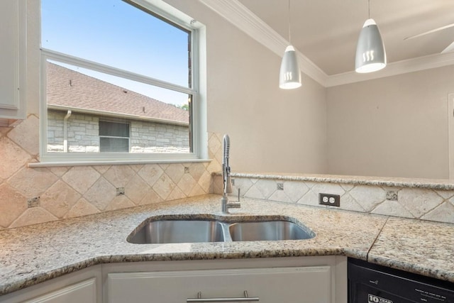 kitchen with crown molding, dishwasher, a sink, and decorative backsplash