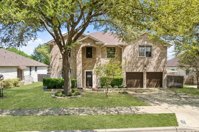 traditional home with concrete driveway, a front yard, an attached garage, and fence