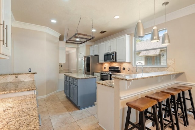 kitchen with stainless steel appliances, crown molding, light stone counters, a peninsula, and backsplash