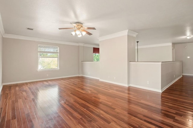 empty room featuring ceiling fan, hardwood / wood-style flooring, crown molding, and baseboards