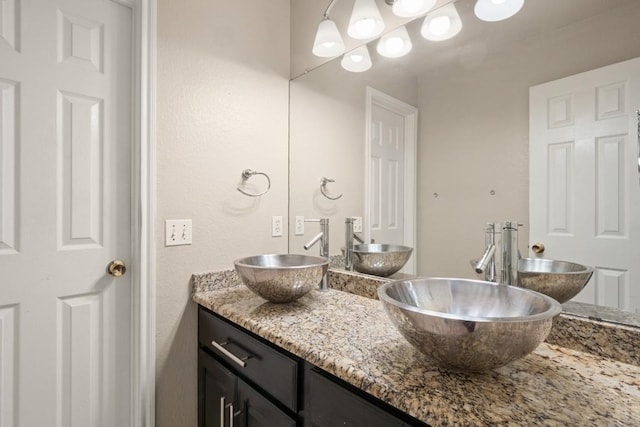 bathroom with double vanity and a sink