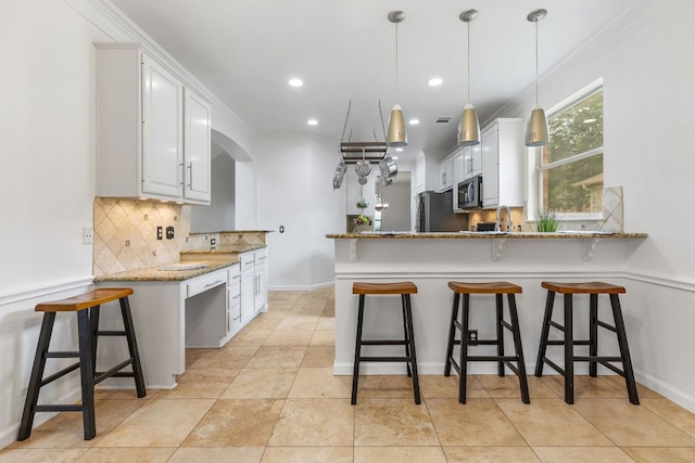 1103 Vanderbilt Cir, Pflugerville, TX 78660 - kitchen with stainless steel appliances, a peninsula, decorative backsplash, light stone counters, and white cabinetry