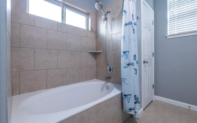 full bath featuring tiled shower / bath and baseboards
