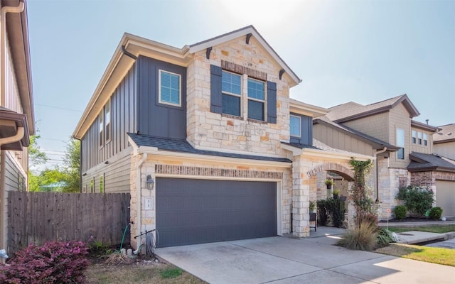 7337 Menchaca Rd Unit 31, Austin, TX 78745 - view of front facade with stone siding, board and batten siding, a garage, and concrete driveway