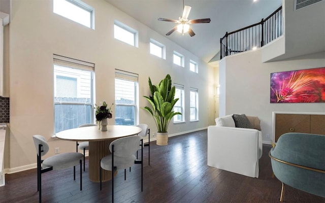 dining area featuring a wealth of natural light, dark wood-style floors, baseboards, and ceiling fan