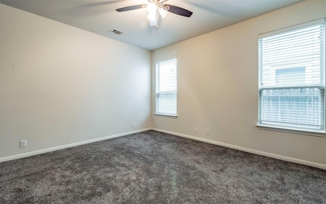 spare room featuring baseboards, visible vents, ceiling fan, and carpet flooring