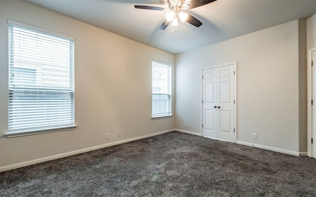 7337 Menchaca Rd Unit 31, Austin, TX 78745 - unfurnished bedroom featuring carpet floors, baseboards, and a ceiling fan